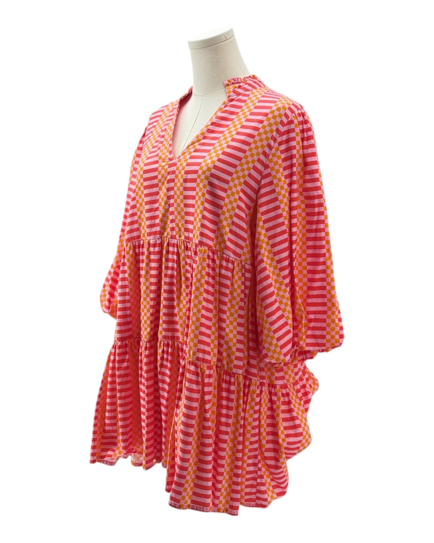 Pink and orange striped dress on a mannequin against a white background