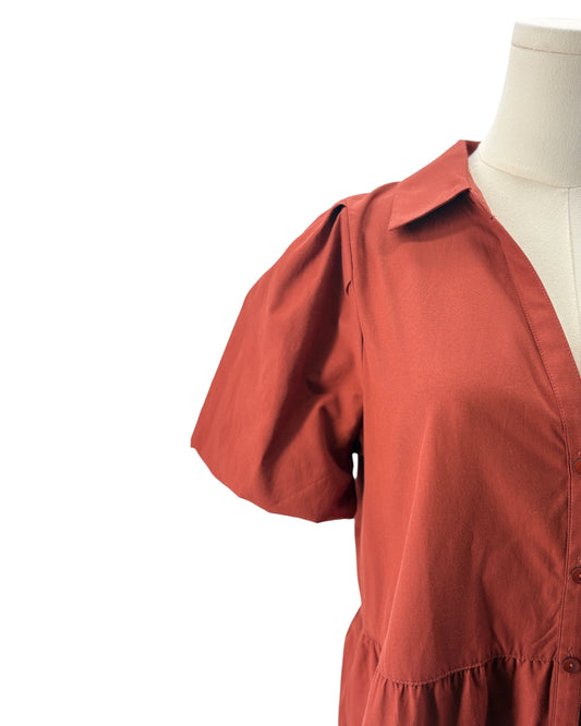 Burnt Orange dress on a mannequin against a white background