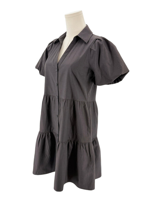 A black short-sleeve tiered shirt dress displayed on a mannequin torso against a plain white background.
