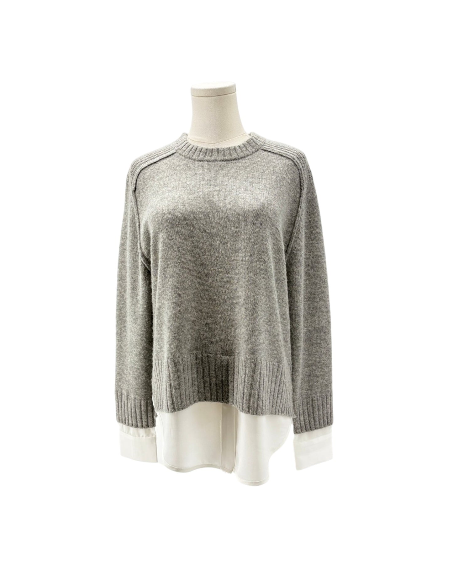 A light gray knit sweater displayed on a mannequin torso against a plain white background.