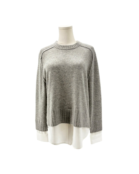 A light gray knit sweater displayed on a mannequin torso against a plain white background.