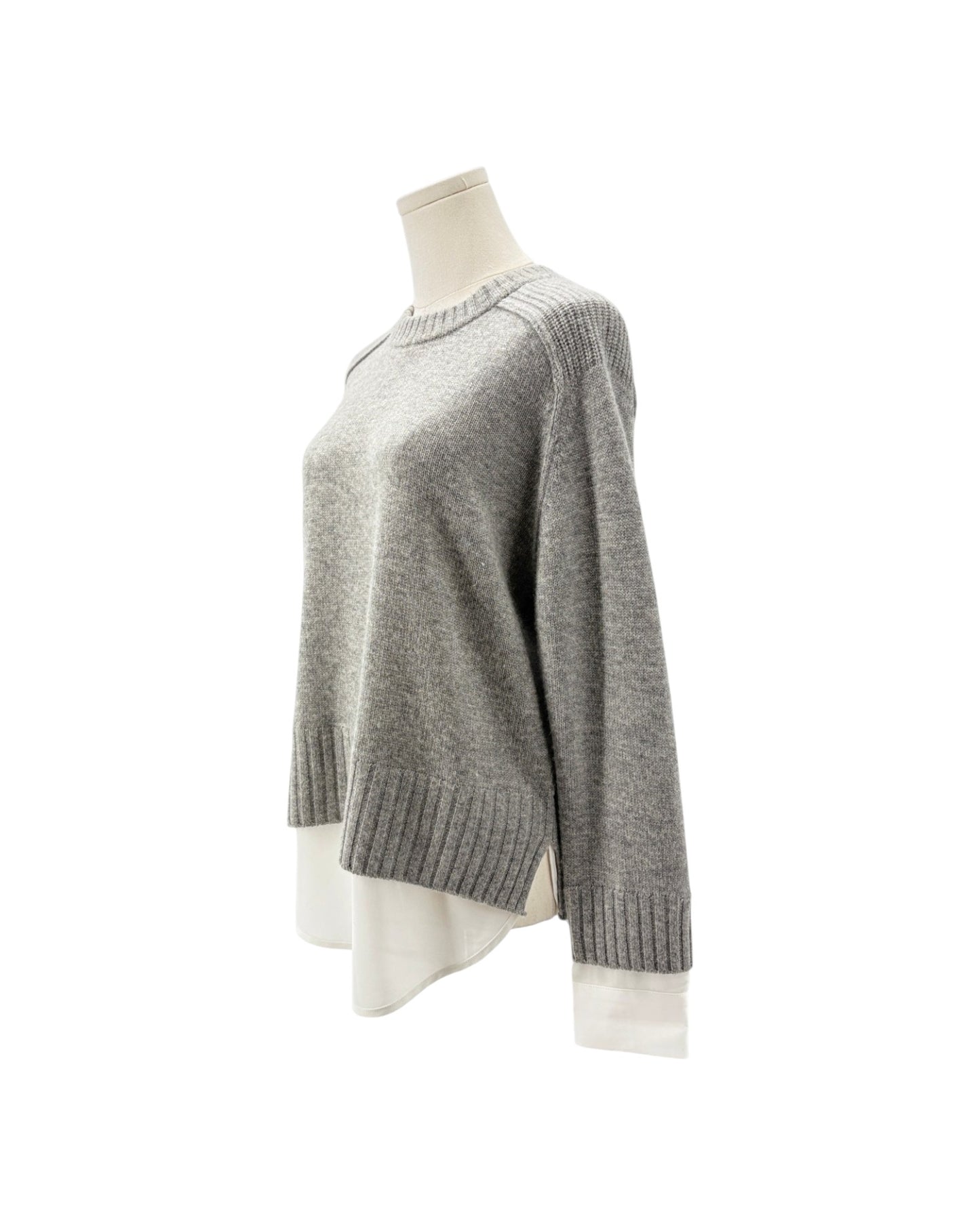 A light gray knit sweater displayed on a mannequin torso against a plain white background.
