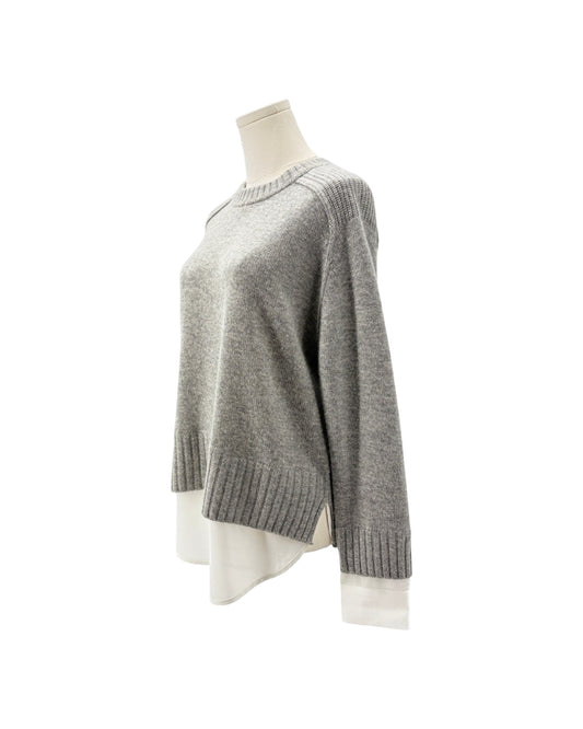A light gray knit sweater displayed on a mannequin torso against a plain white background.