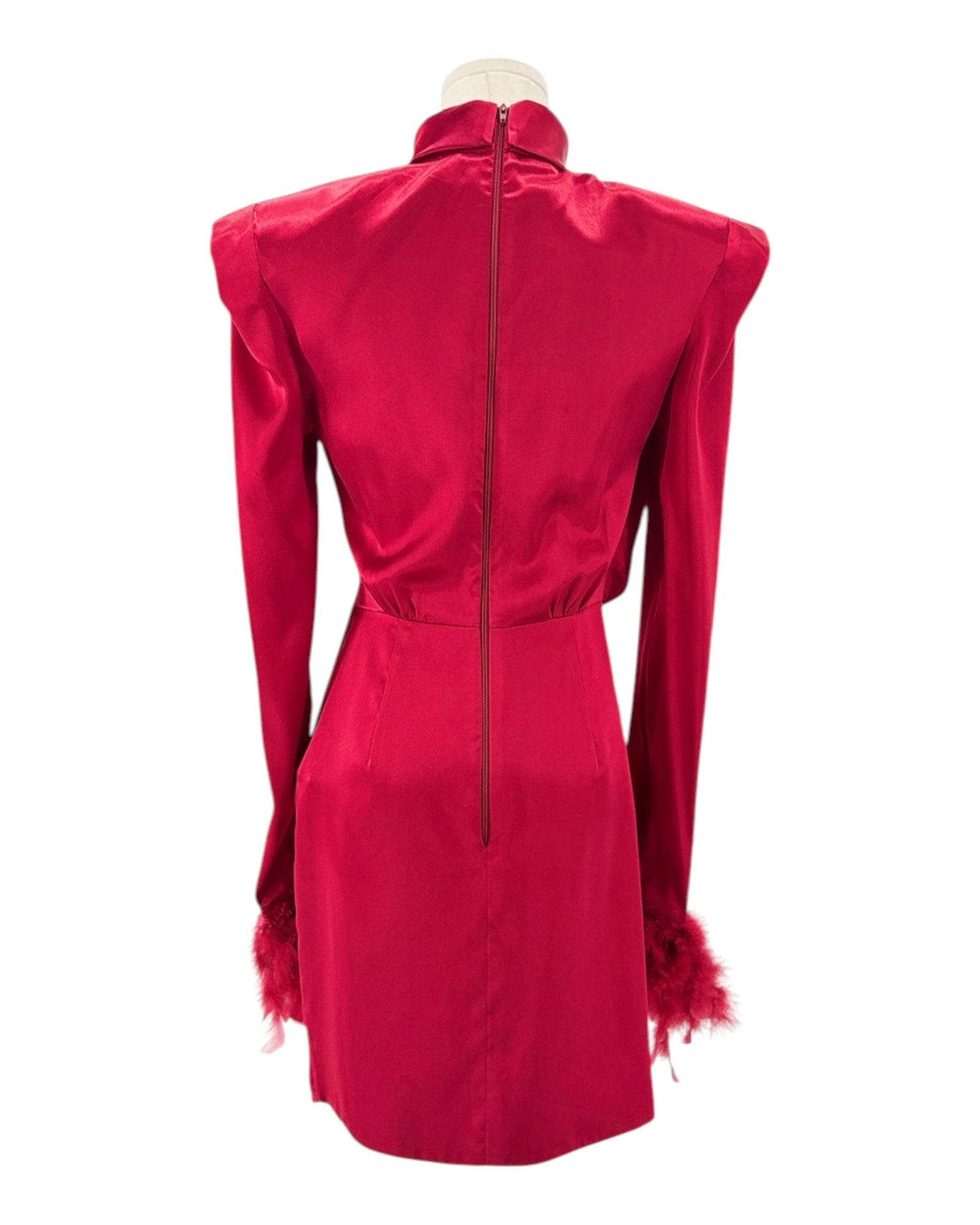 Red dress with feathered shoulders on a mannequin against a white background