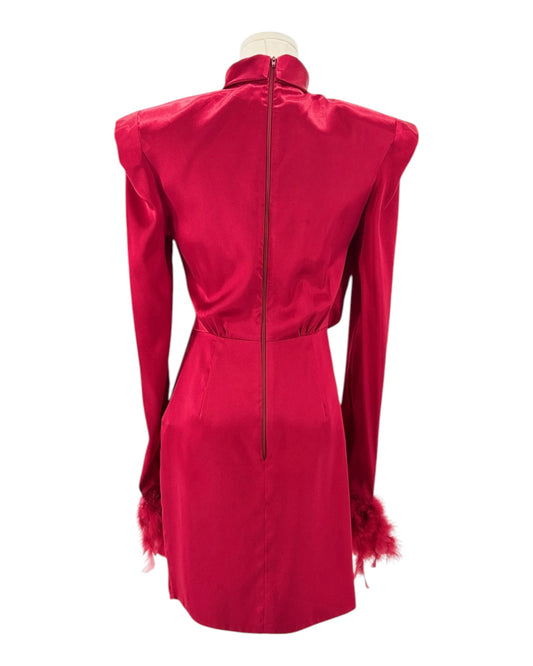 Red dress with feathered shoulders on a mannequin against a white background