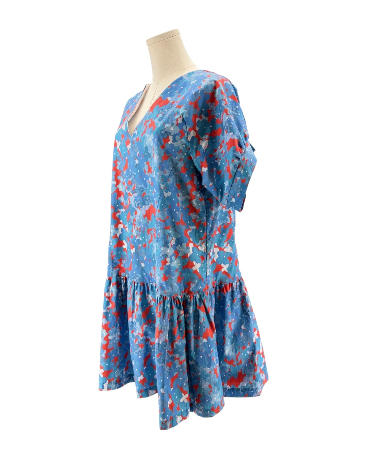 Blue floral dress on a mannequin against a white background