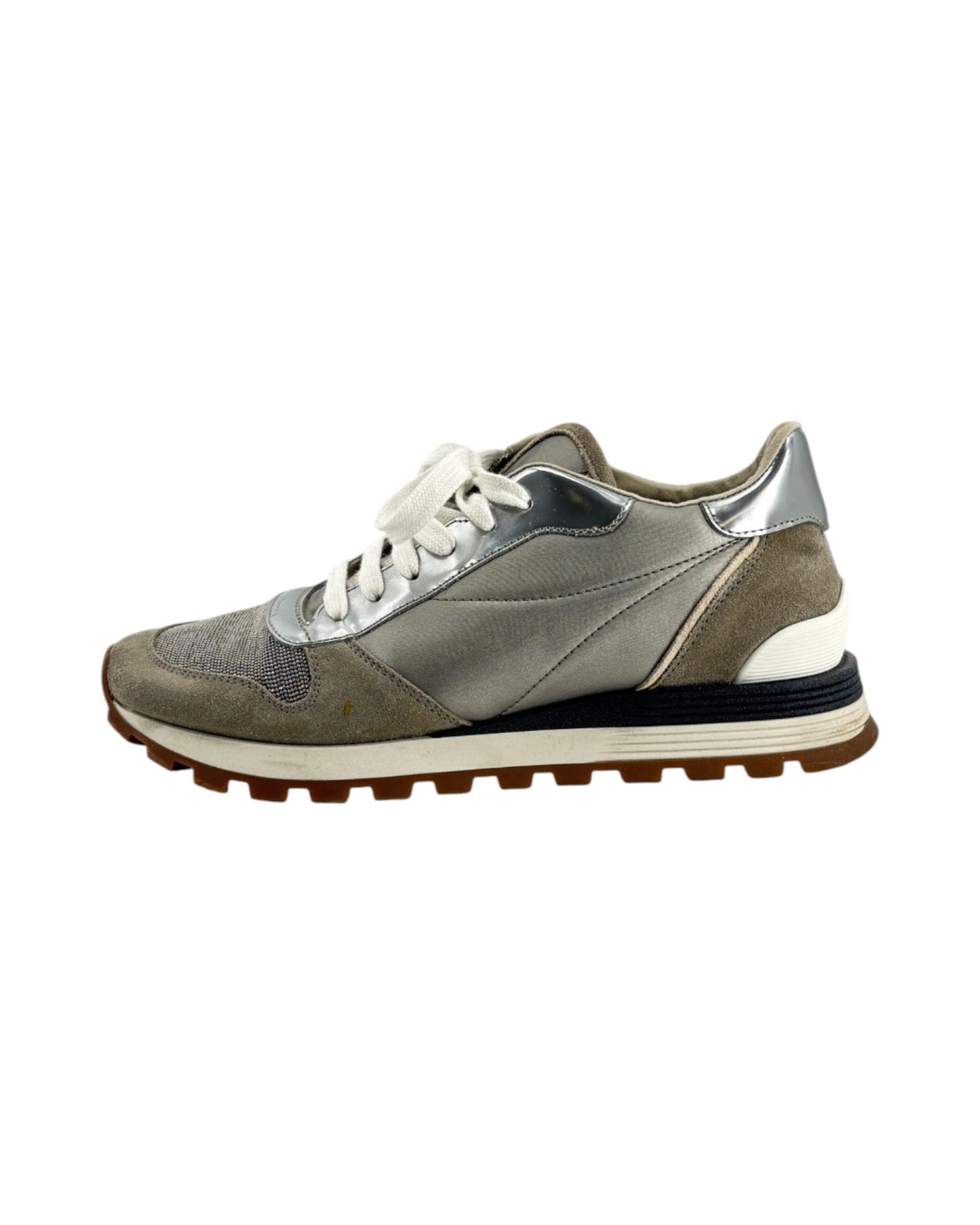 Gray and white sneaker with a brown sole on a white background