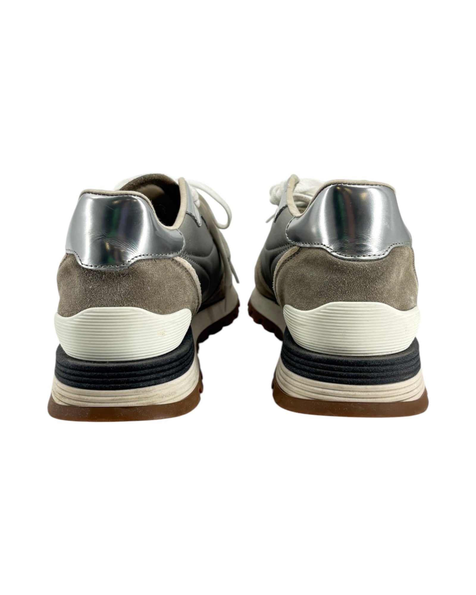 Pair of gray and silver sneakers on a white background