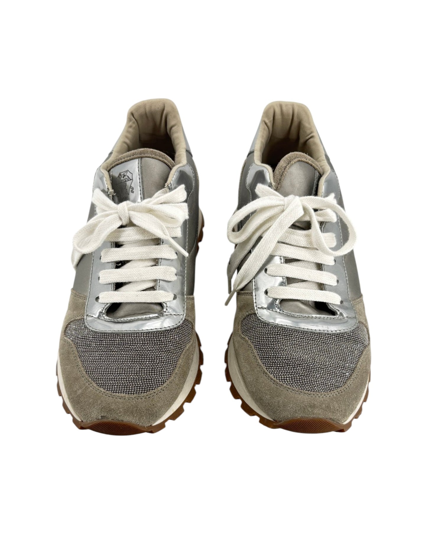 Pair of gray sneakers with white laces on a white background