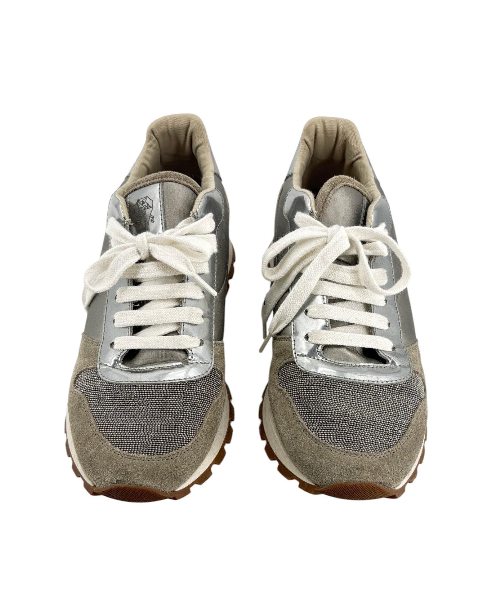 Pair of gray sneakers with white laces on a white background