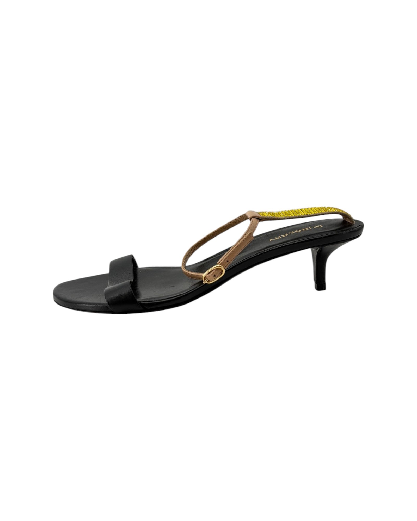 Black sandal with gold strap on a white background