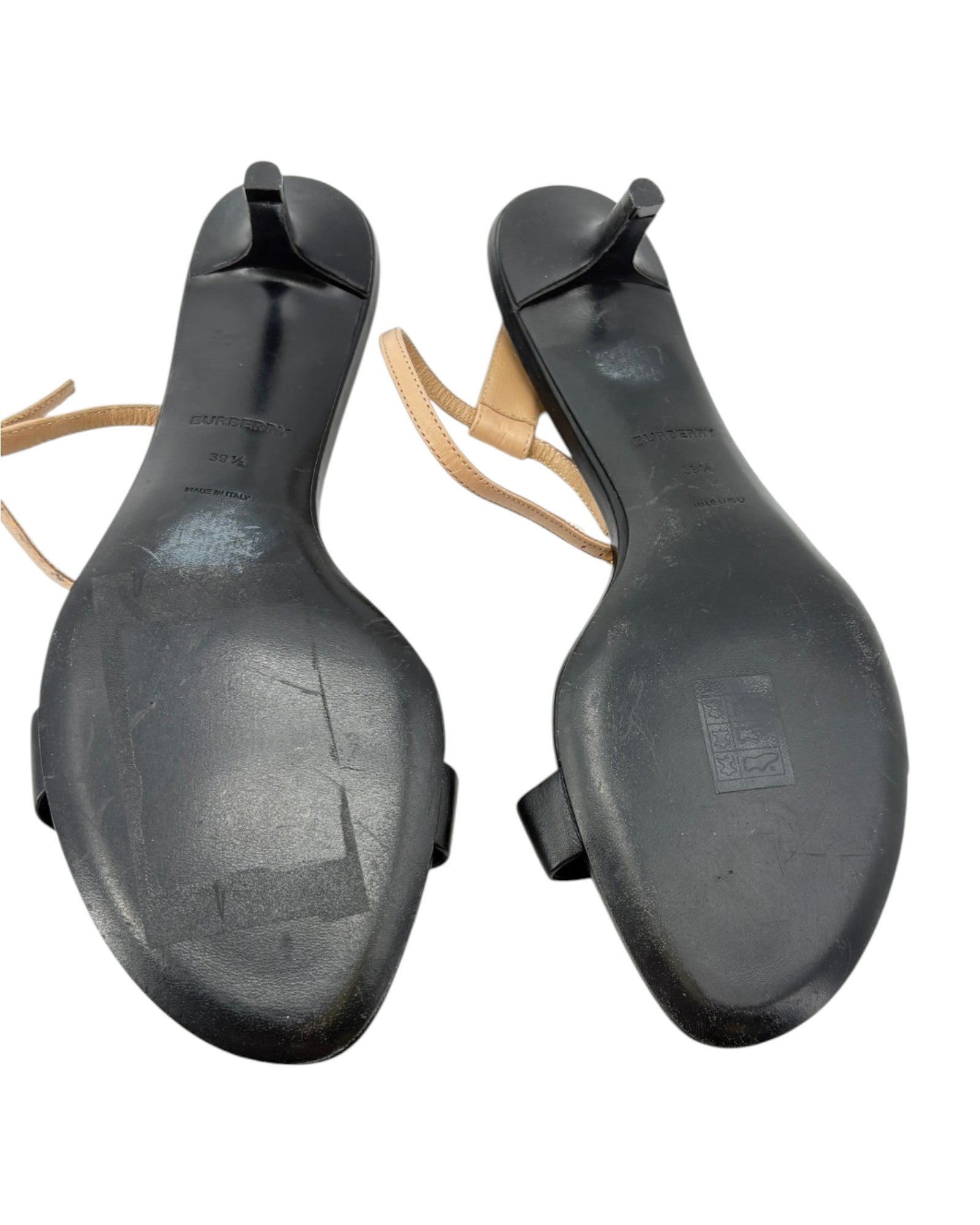 Pair of black shoe soles on a white background