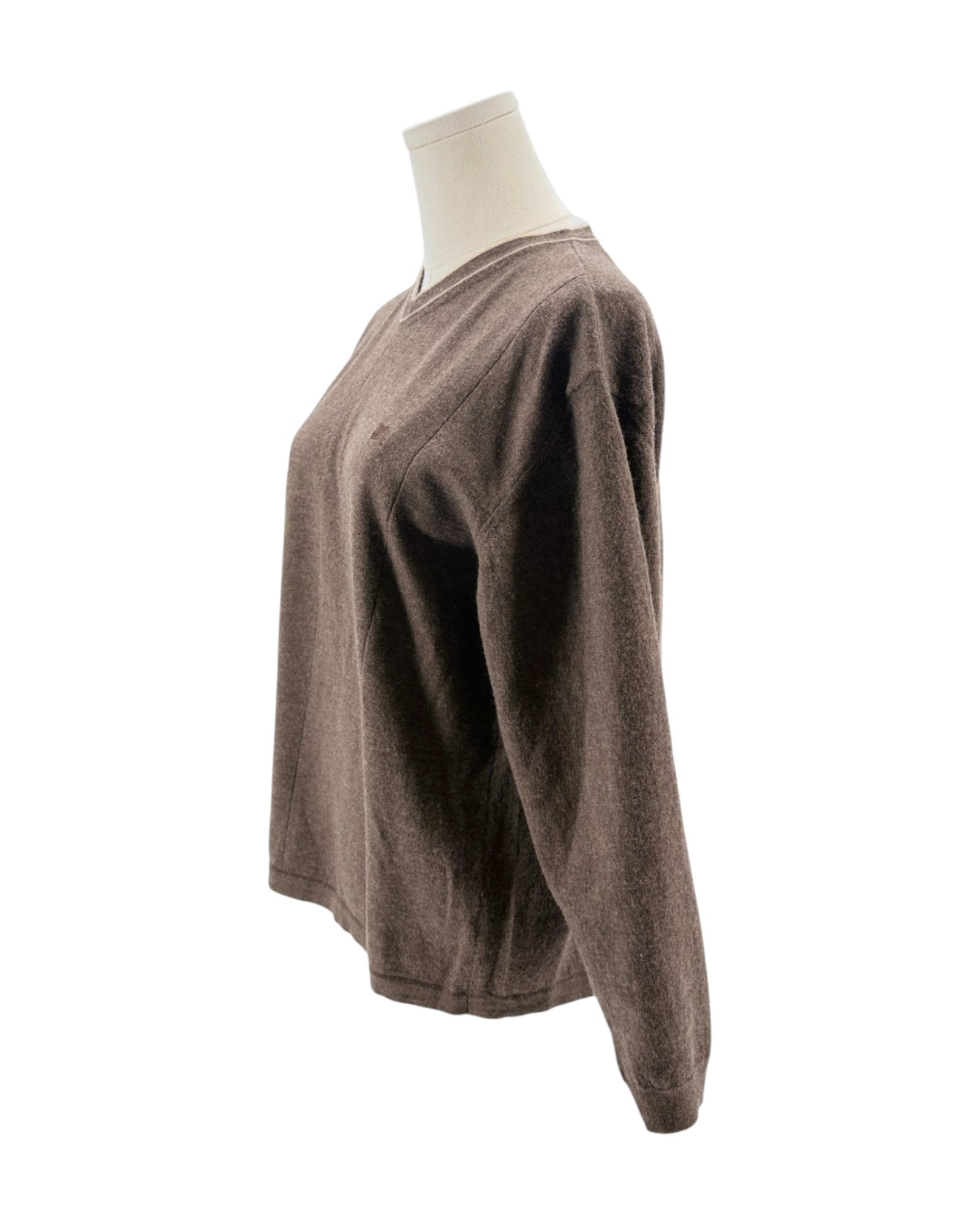 Brown sweater on a mannequin against a white background