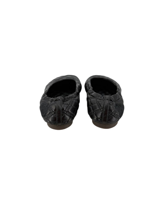 A pair of black quilted leather slip-on slippers with a textured pattern, shown from a top-down view on a plain white background.