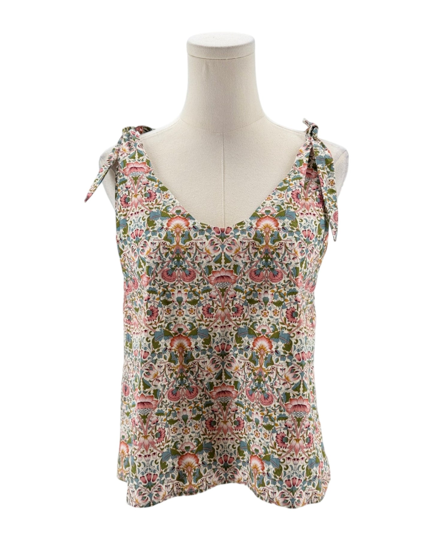Floral patterned tank top on a mannequin against a white background