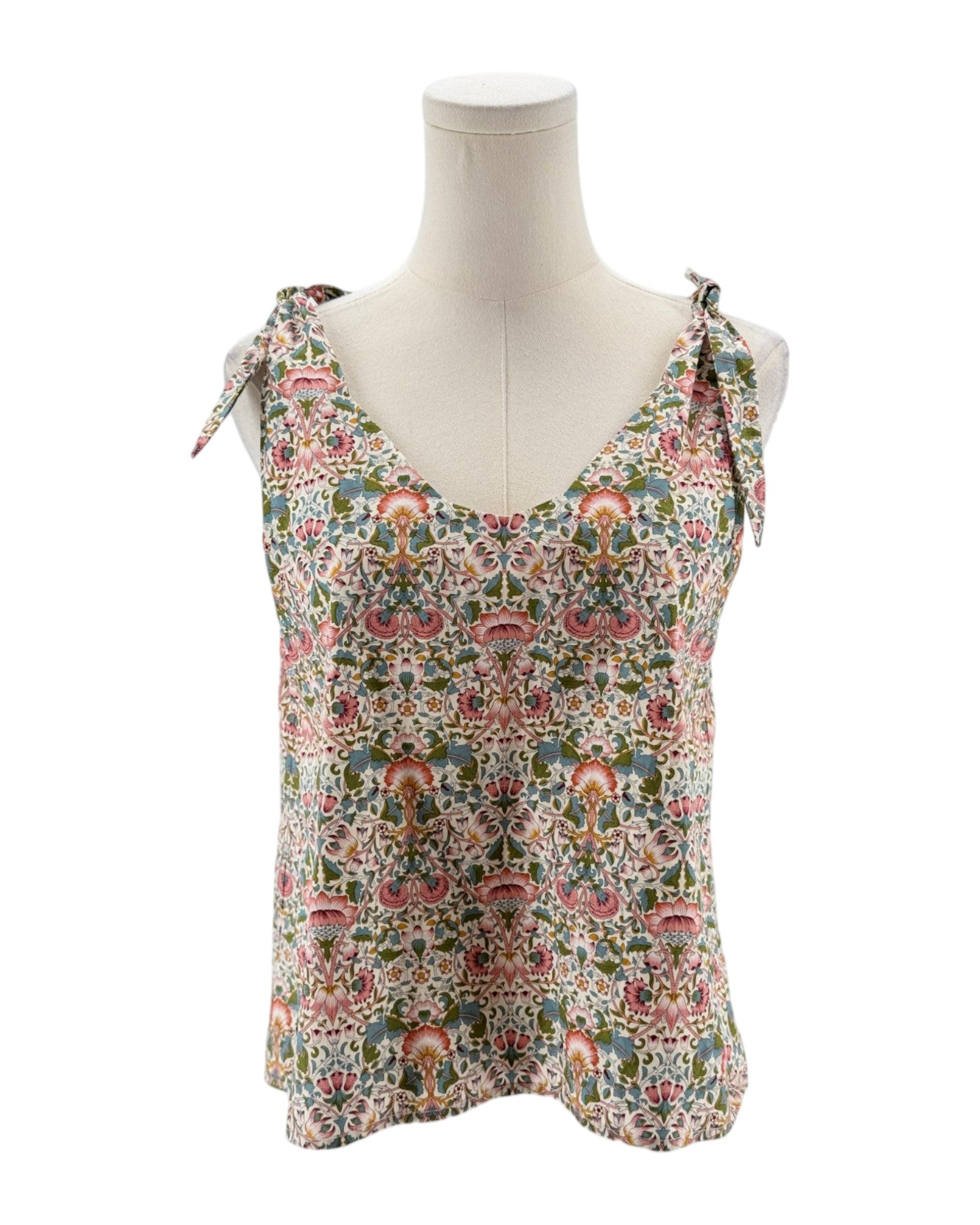 Floral patterned tank top on a mannequin against a white background