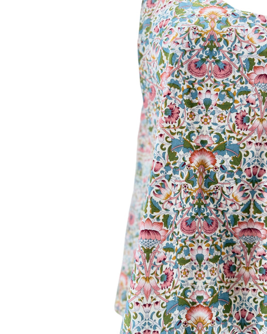 Close-up of a floral patterned fabric with vibrant colors on a white background