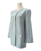 Tweed blazer with white buttons on a mannequin against a white background