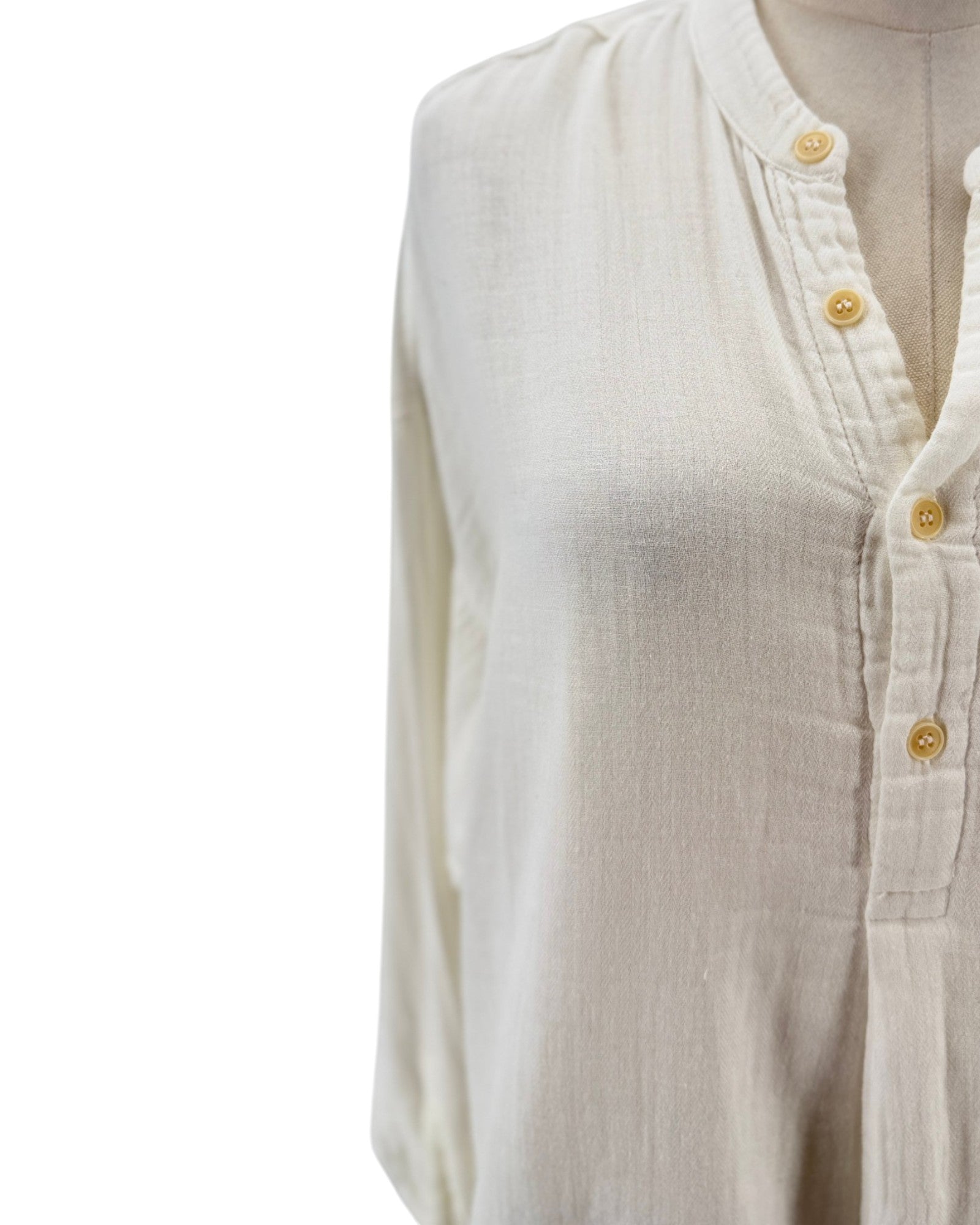 White button-up shirt on a mannequin with a white background