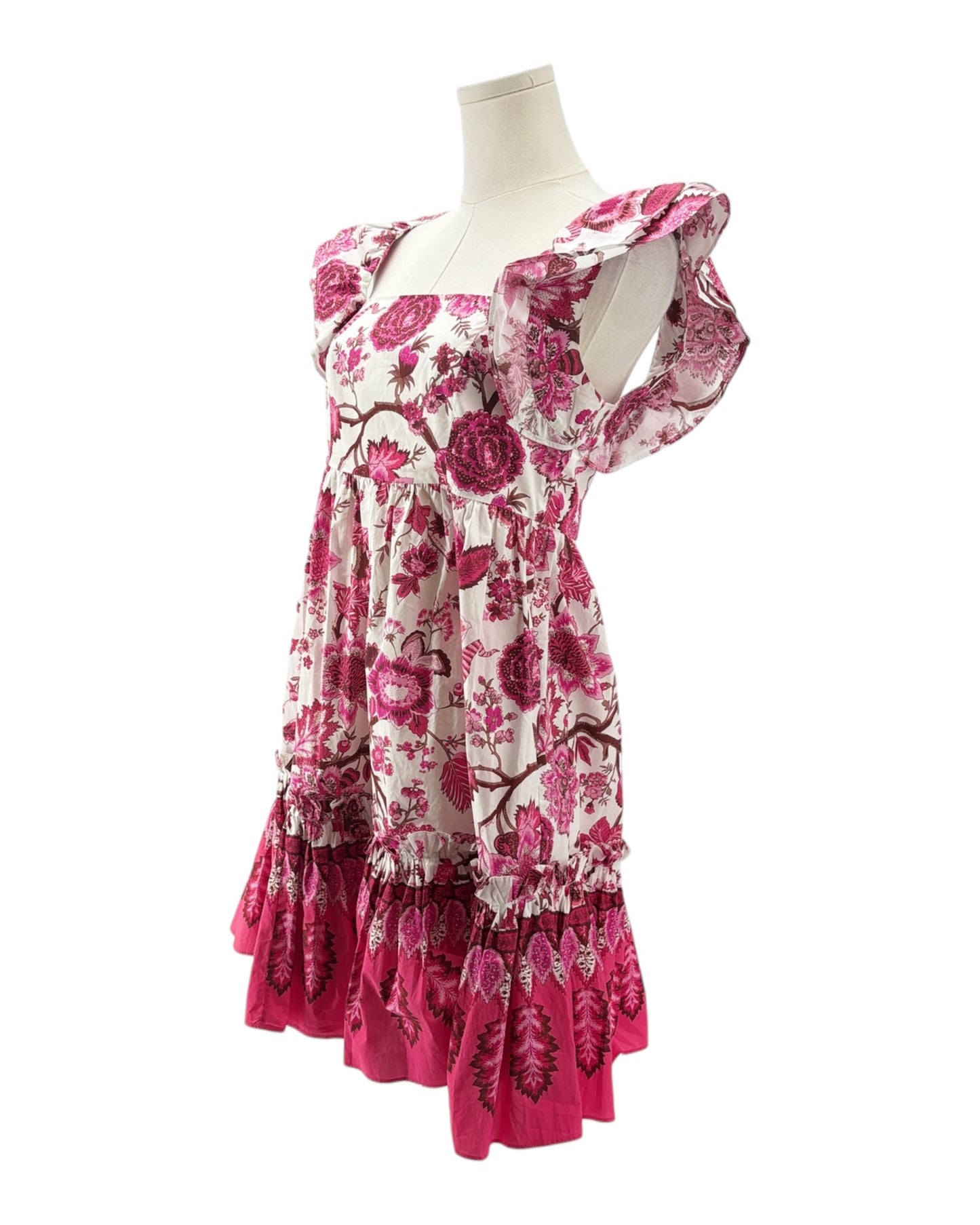 Pink floral dress on a mannequin against a white background