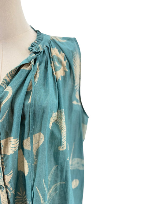 Teal dress with floral pattern on a mannequin against a white background