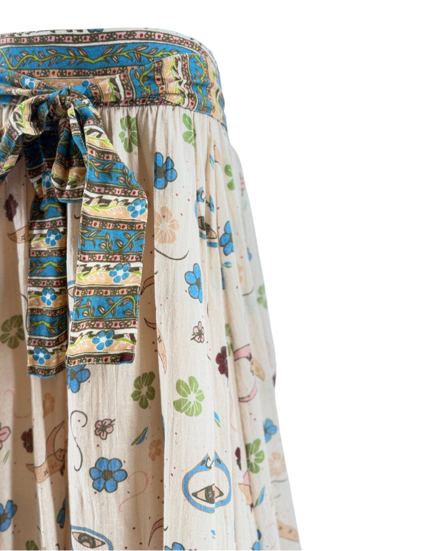 Colorful patterned fabric with a focus on a decorative belt and skirt.