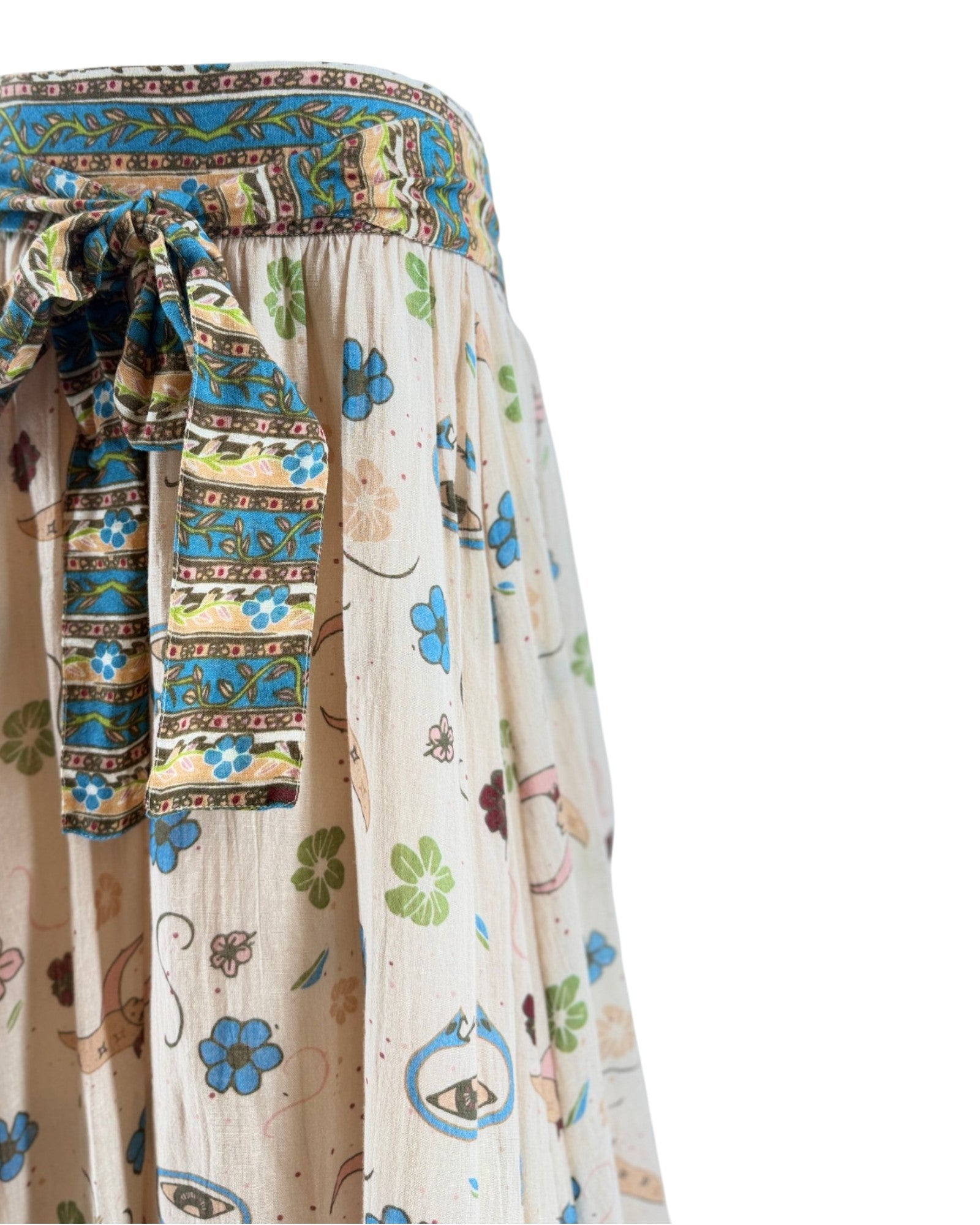 Colorful patterned fabric with a focus on a decorative belt and skirt.