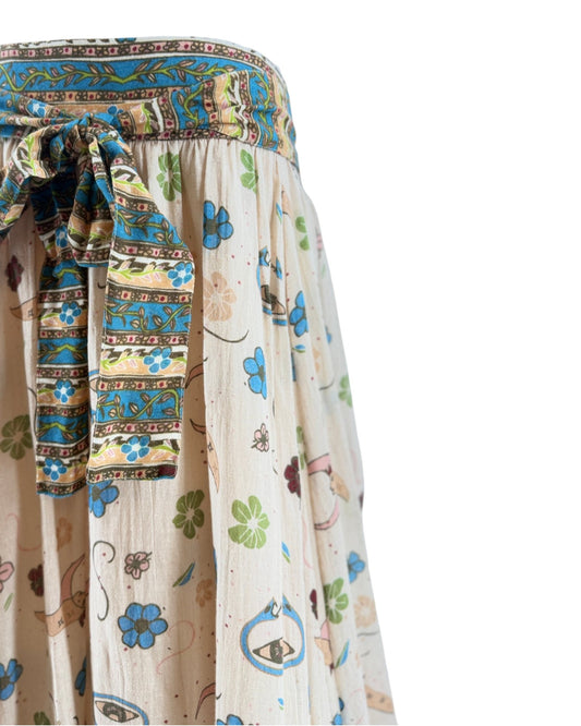Colorful patterned fabric with a focus on a decorative belt and skirt.