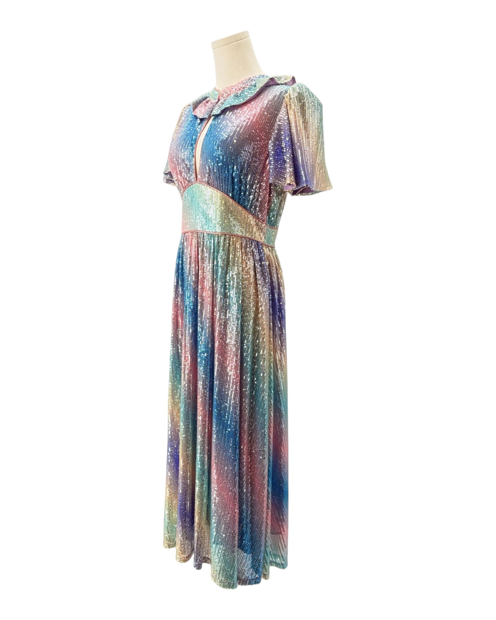 Multicolored dress on a mannequin against a white background
