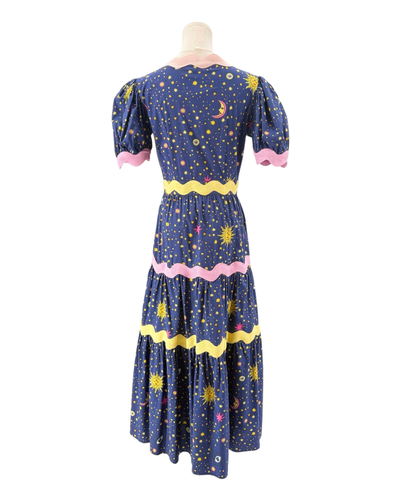 Celia B Navy dress with celestial pattern on a mannequin against a white background