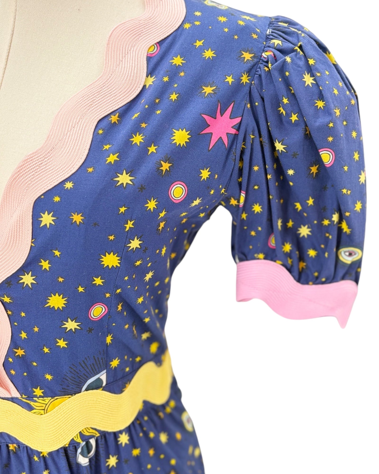 Celia B Navy dress with celestial pattern on a mannequin against a white background