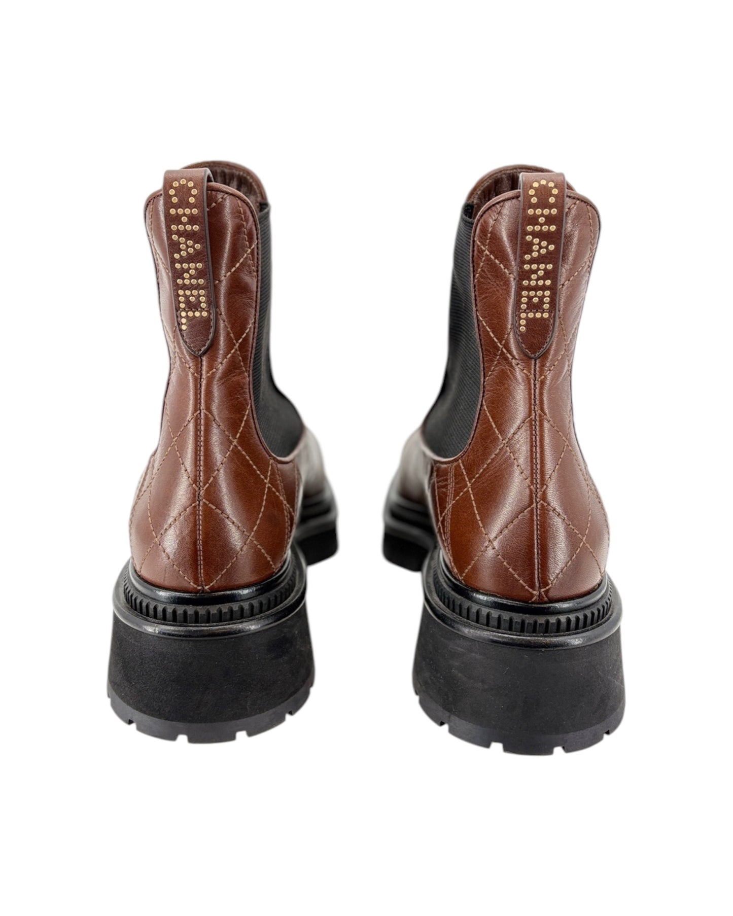 Brown leather boots with black soles on a white background
