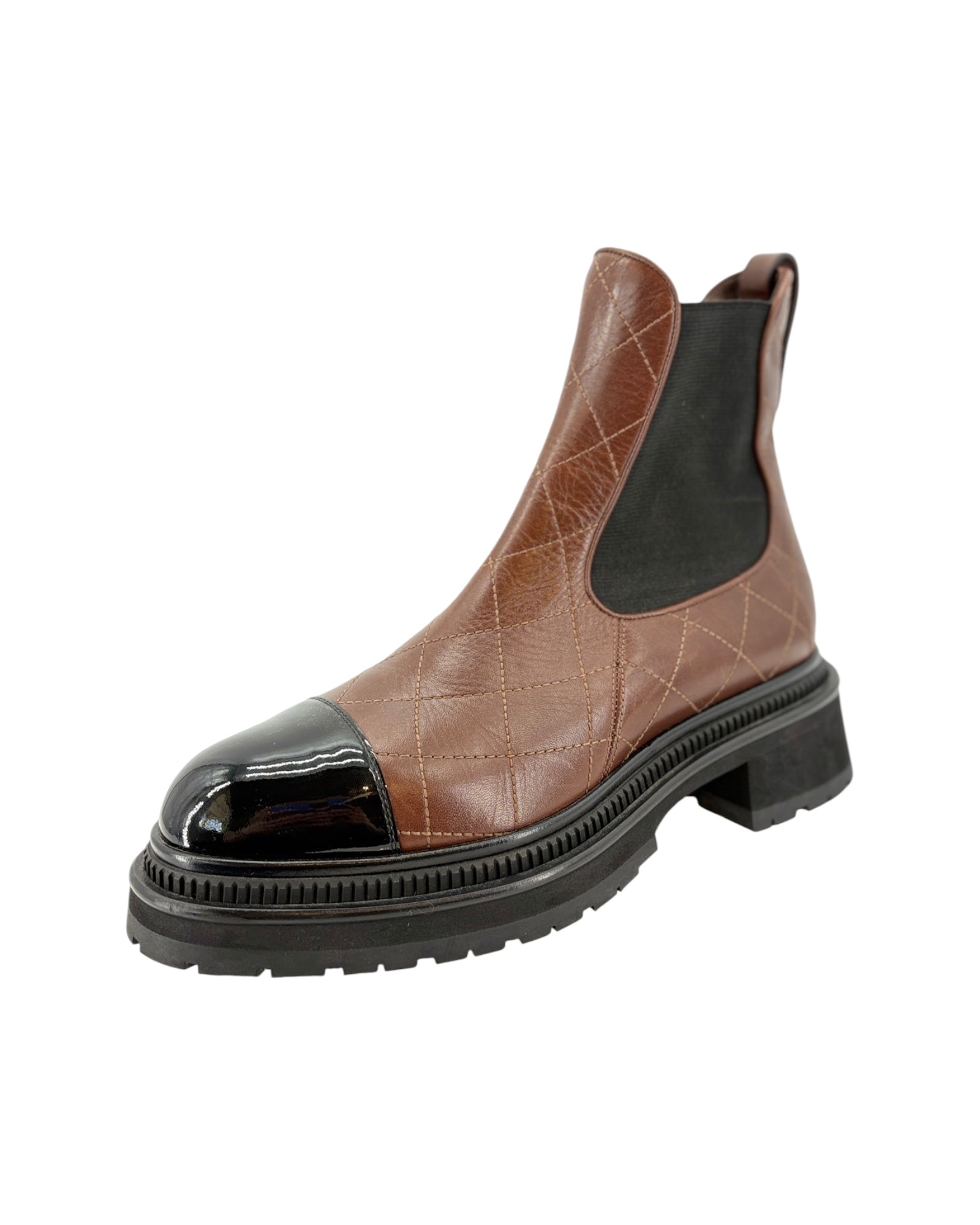 Brown leather Chelsea boot with black sole on a white background