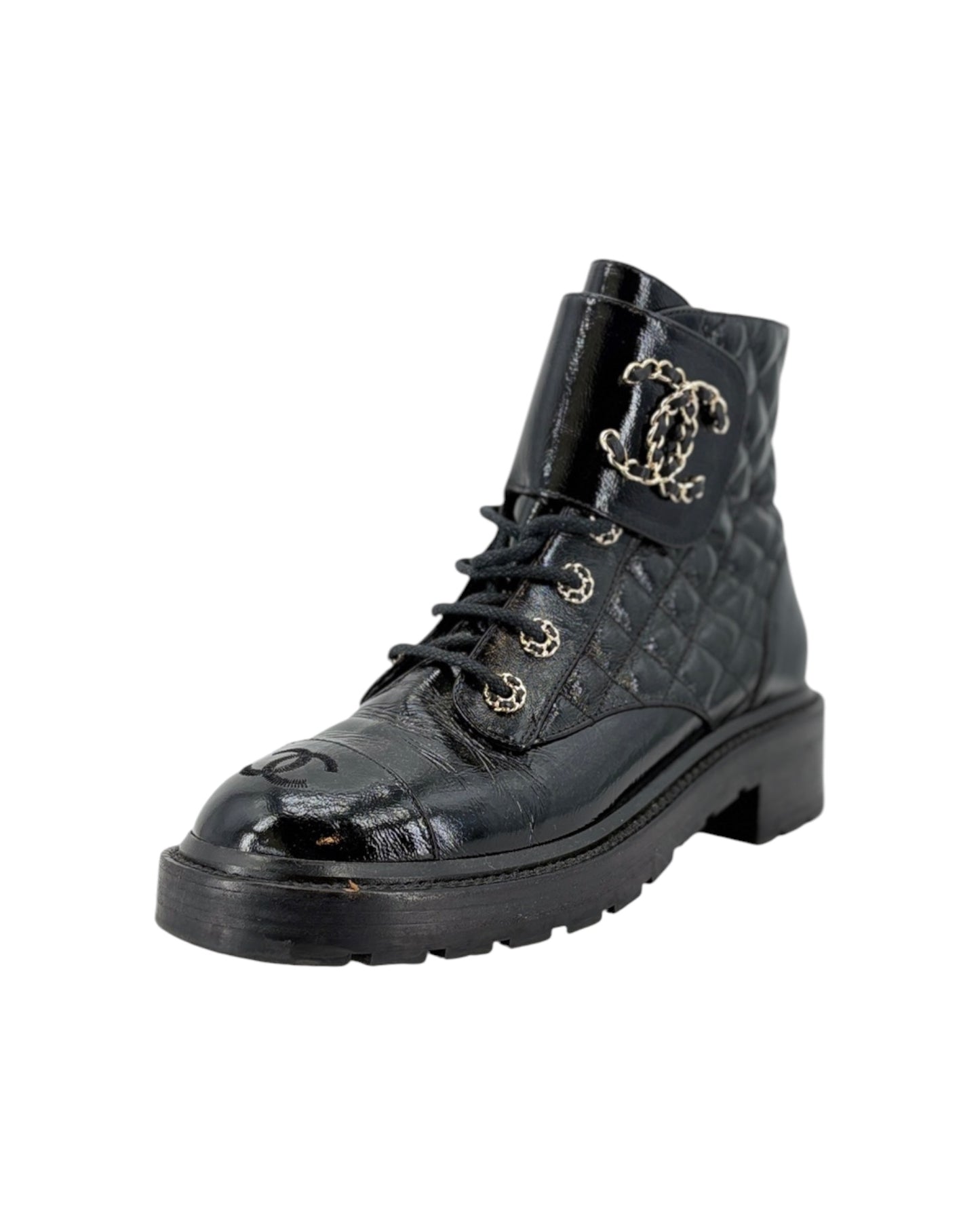 Black quilted leather boot with silver logo on a white background