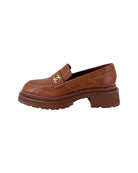 Chanel brown loafers with gold CC logo on a white background