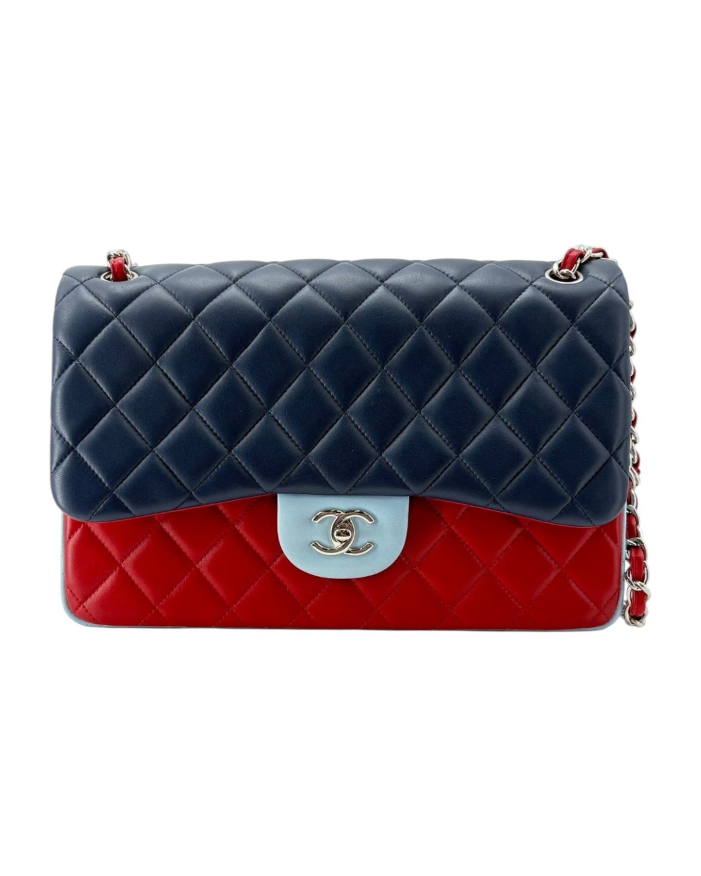 Chanel bag with navy blue top half and red bottom half on a white background