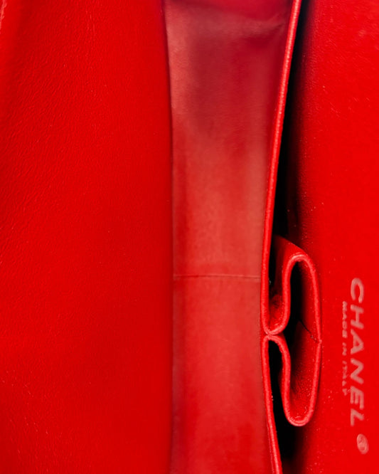 Close-up of a red Chanel handbag with visible branding.