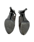 Pair of black shoe trees on a white background
