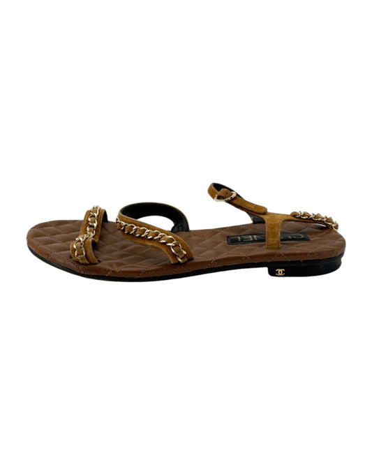 Brown sandal with chain detail on a white background