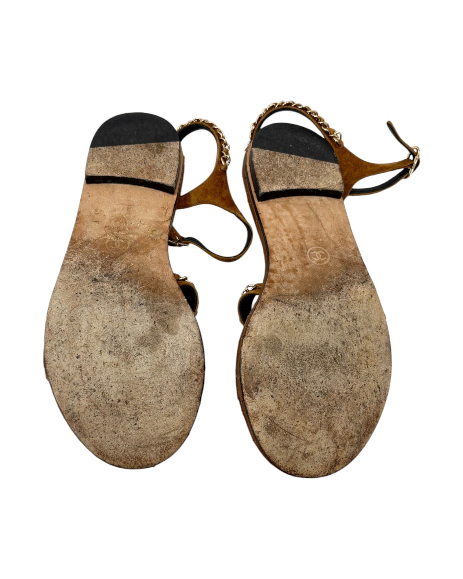 Pair of worn-out sandals on a white background
