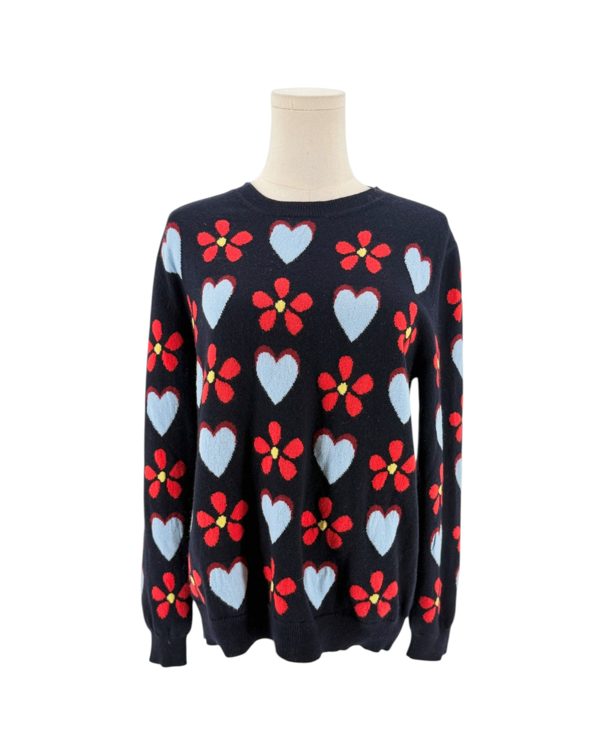 Navy sweater with hearts and flowers on a mannequin with a white background