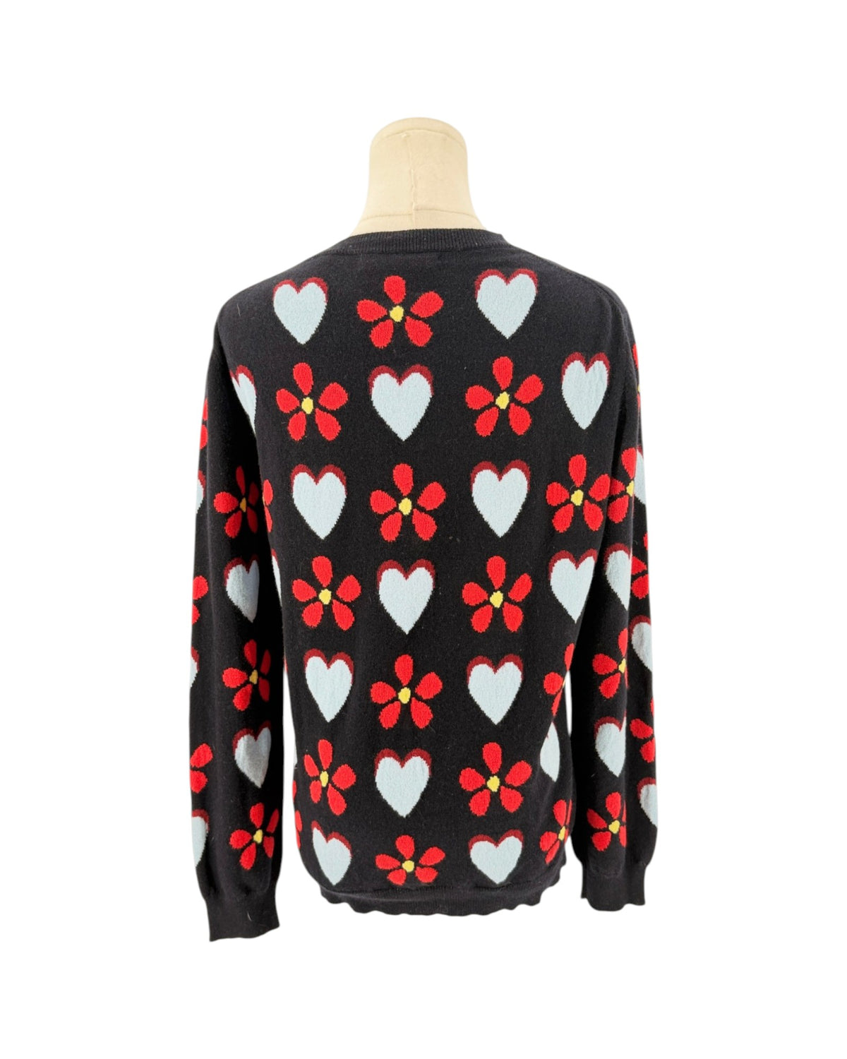 Navy sweater with hearts and flowers on a mannequin with a white background
