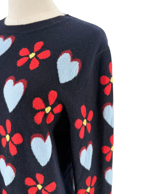 Navy sweater with hearts and flowers on a mannequin with a white background