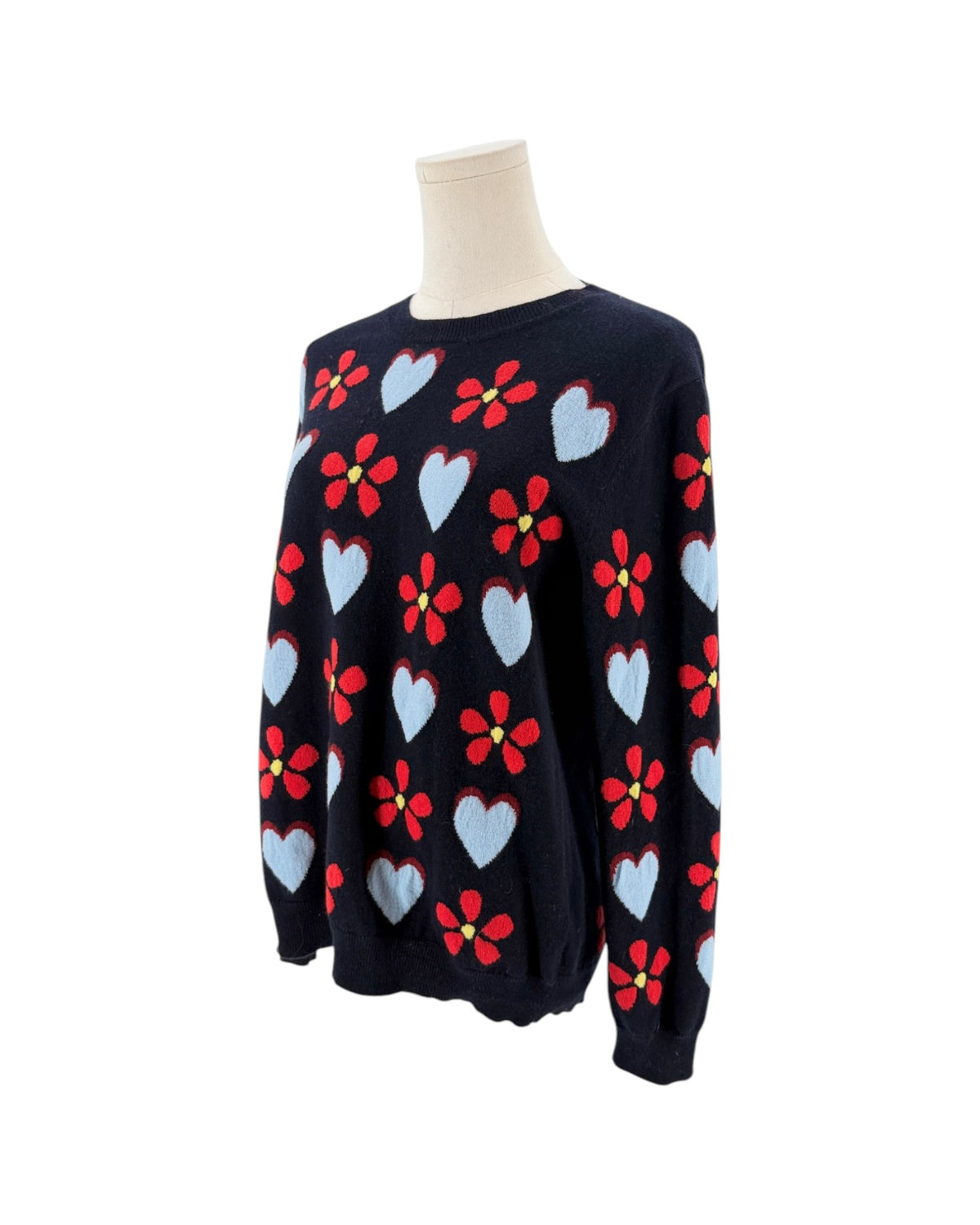 Navy sweater with hearts and flowers on a mannequin with a white background