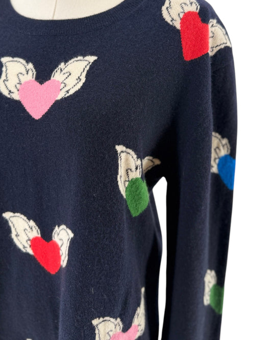Navy blue sweater with colorful flying hearts pattern on a mannequin on a white background