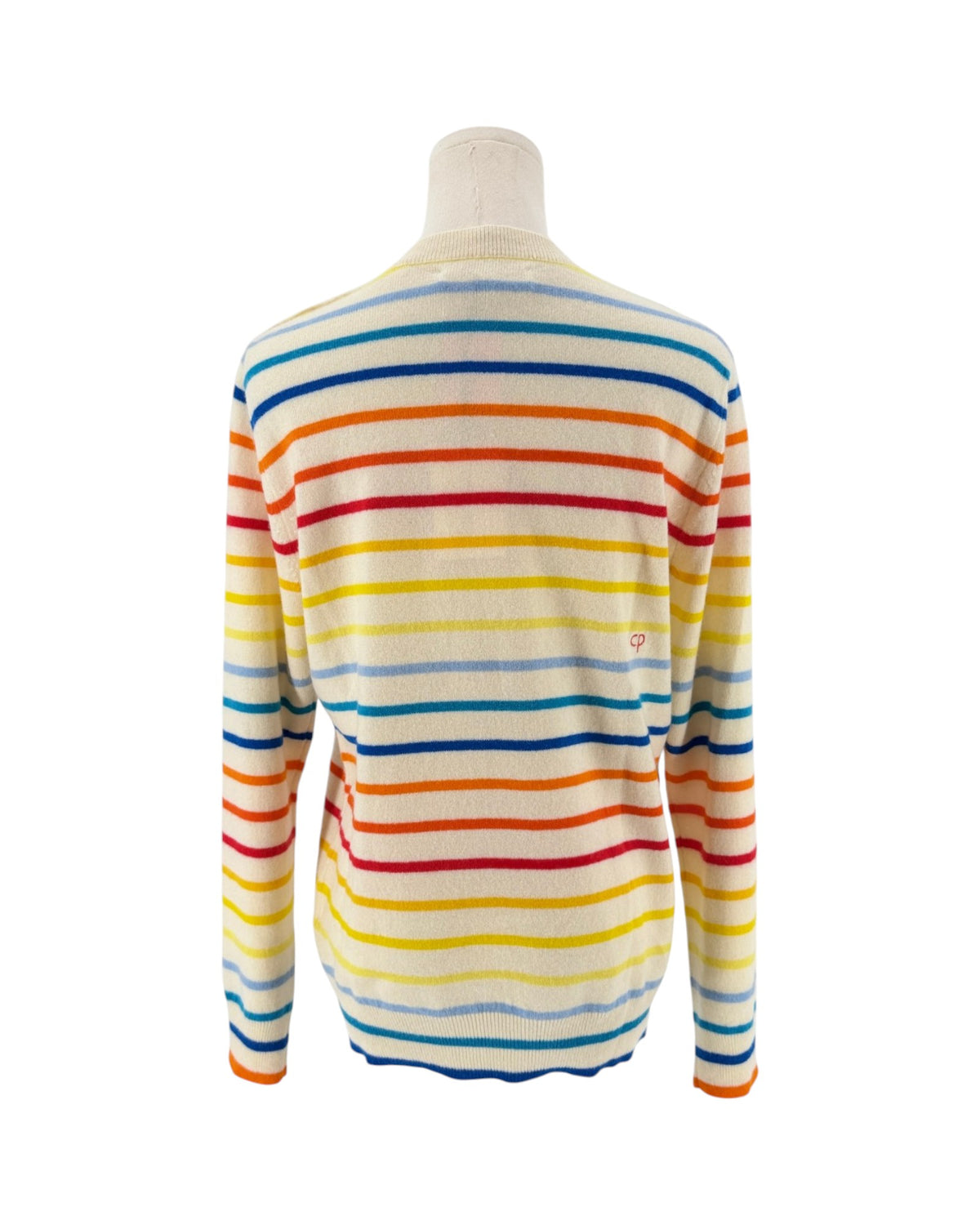A long-sleeve knit sweater with horizontal rainbow stripes in blue, red, yellow, and orange on an off-white base, displayed on a mannequin torso against a white background.
