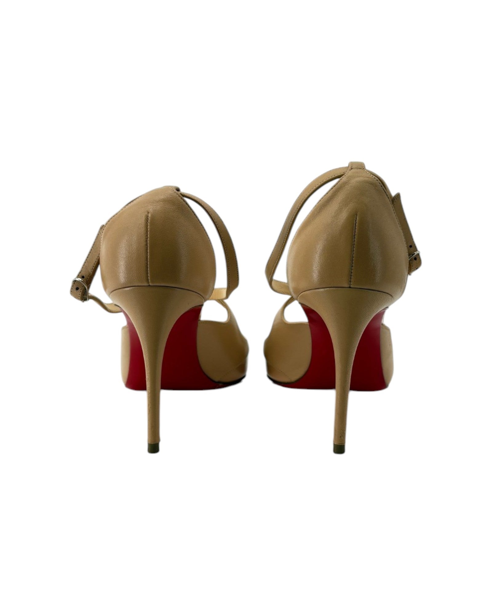 Tan high-heeled shoes with red soles on a white background