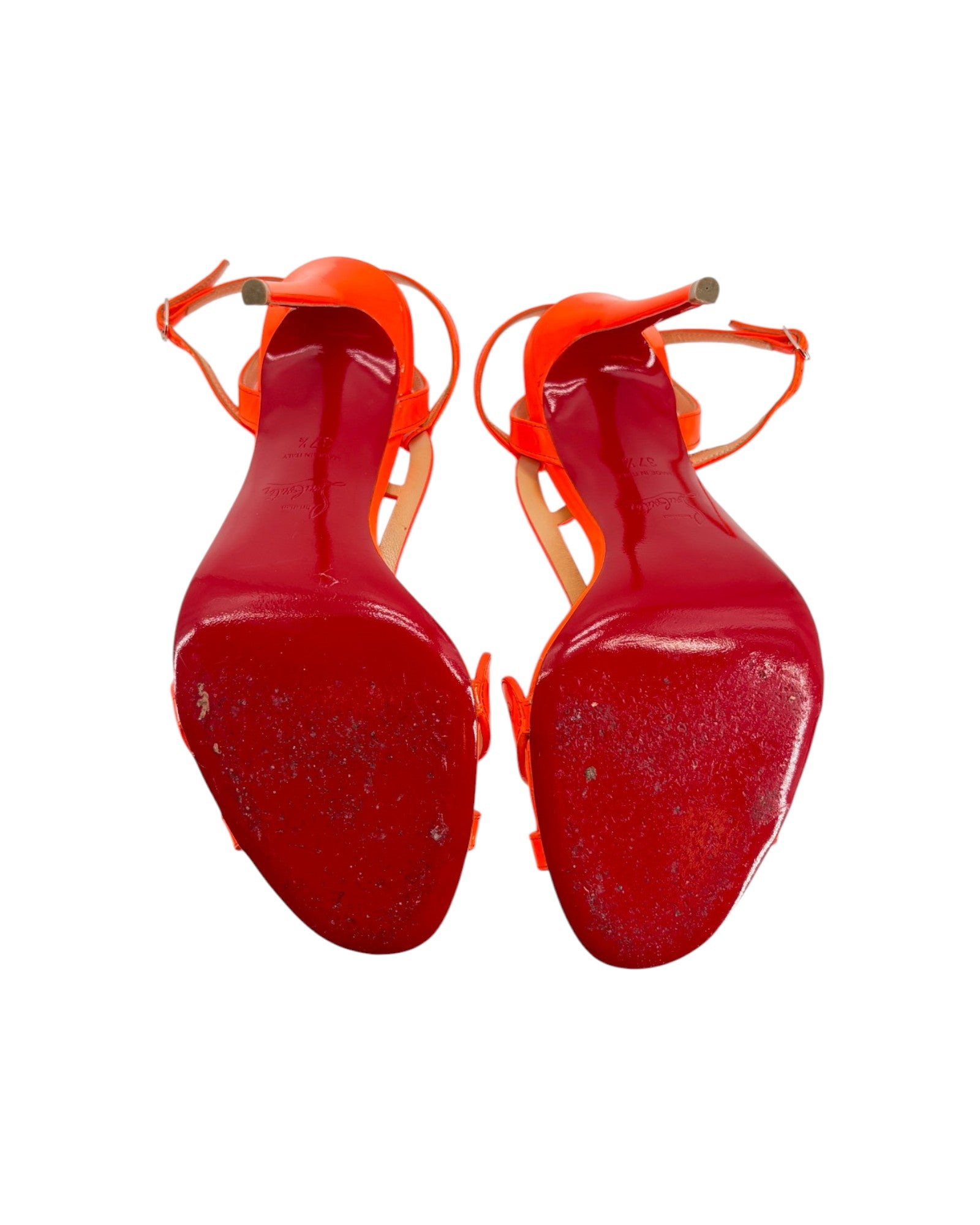 Pair of red high-heeled shoes on a white background