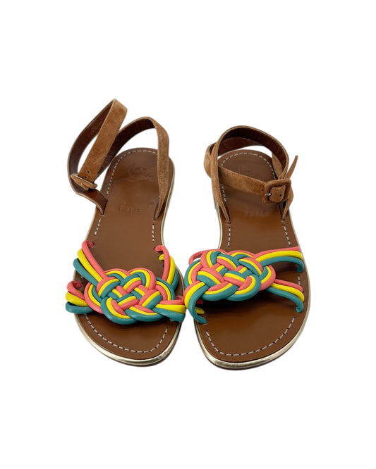Pair of brown sandals with colorful braided straps on a white background