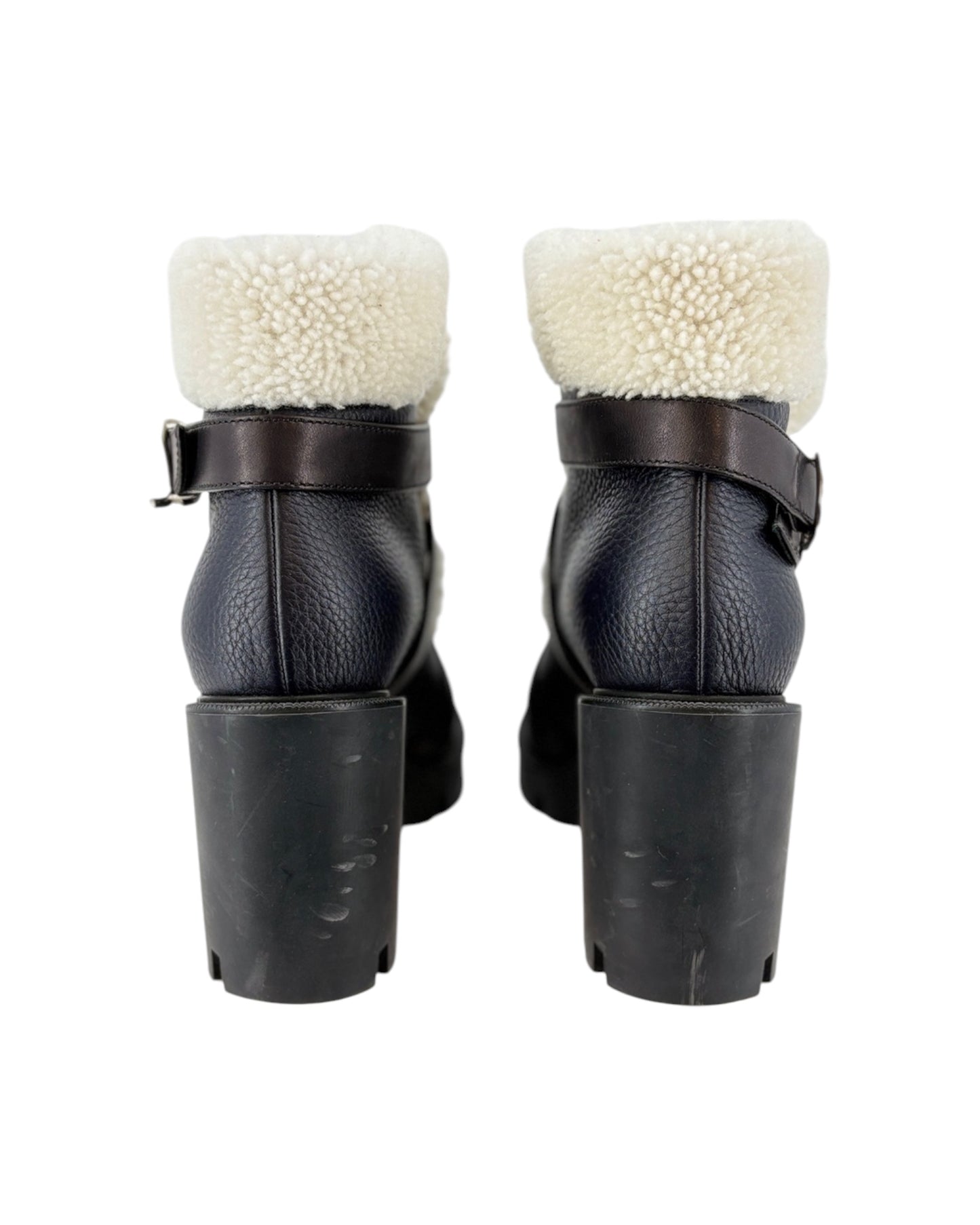 Black leather boots with white fur lining on a white background